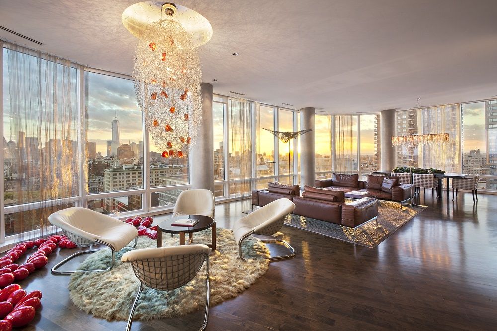modern looking room of a penthouse overlooking the new york skyline